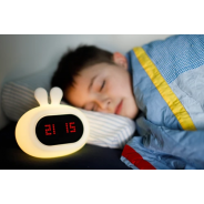 Chłopiec śpiący przy silikonowej lampce nocnej z funkcją zegara.