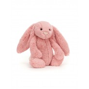 Pluszowa maskotka w kształcie uroczego, różowego króliczka.