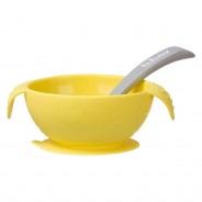 Żółta miska z przyssawką w zestawie z elastyczną łyżeczką.